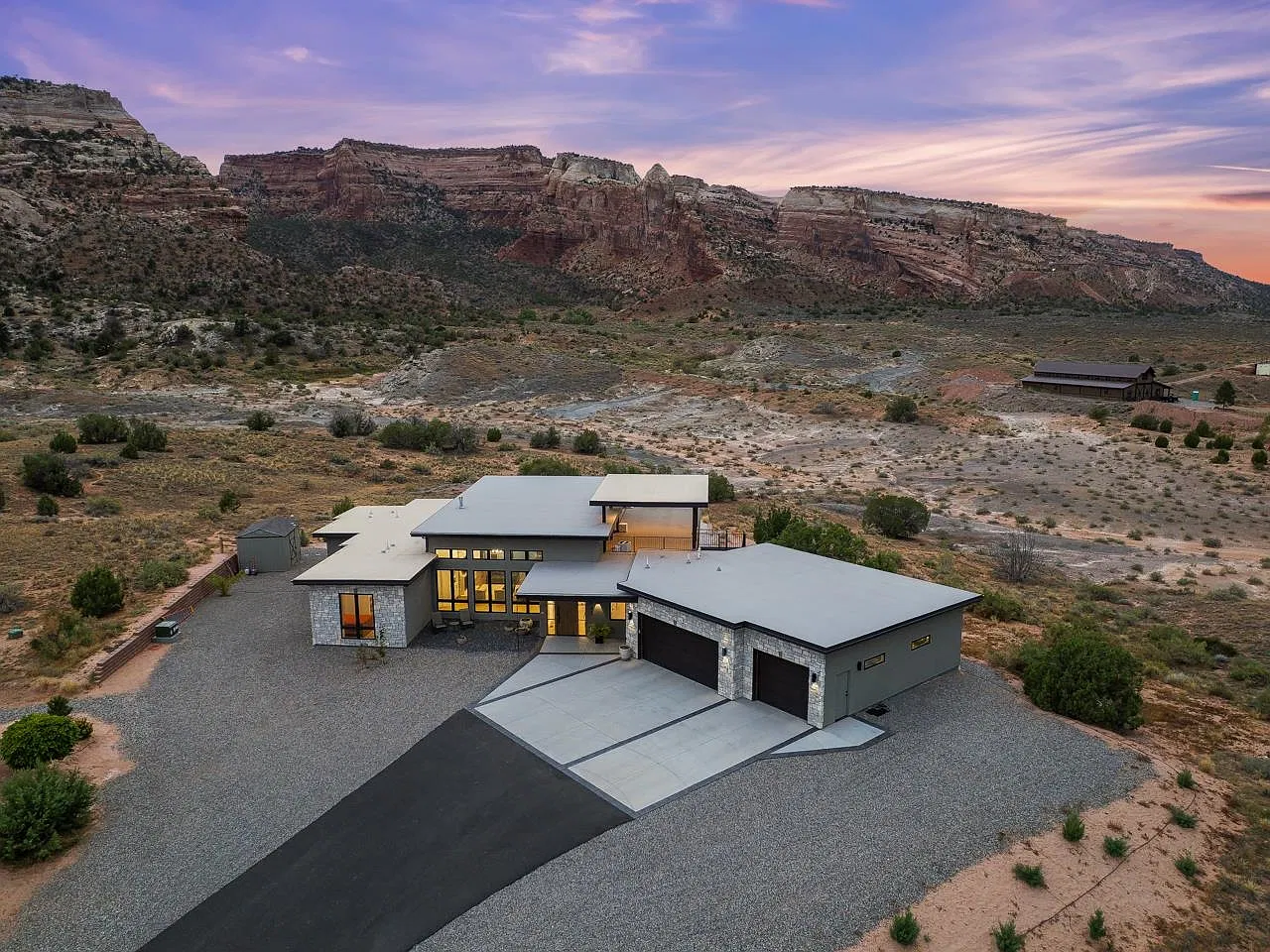 Aerial view of 1843 Broadway at dusk with the Colorado National Monument behind