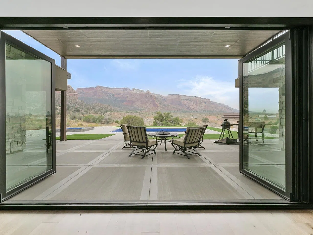 Folding glass wall open to the covered patio and canyon views
