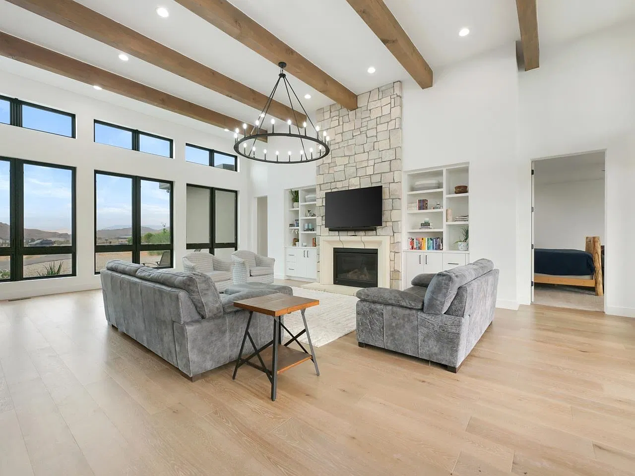 Living room with stone fireplace and built-in shelves