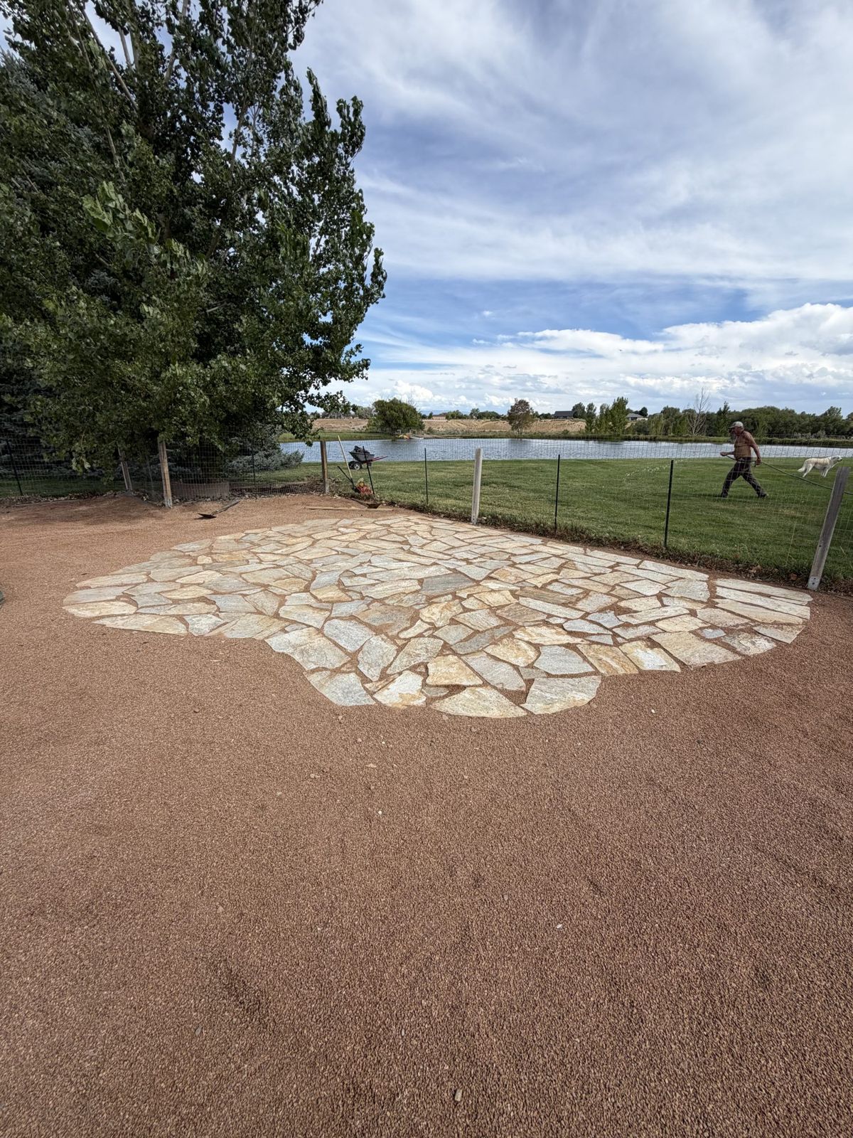 A flagstone patio set in freshly fine-graded ground